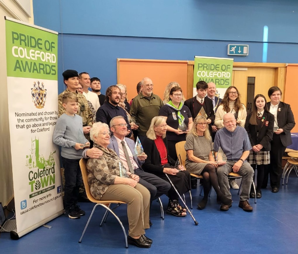 Photo of 2023 award winners sat together for the Pride of Coleford Awards 